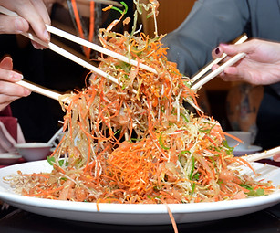 Premium Yee Sang platter with fresh ingredients and salmon, catered for a Lunar New Year event.